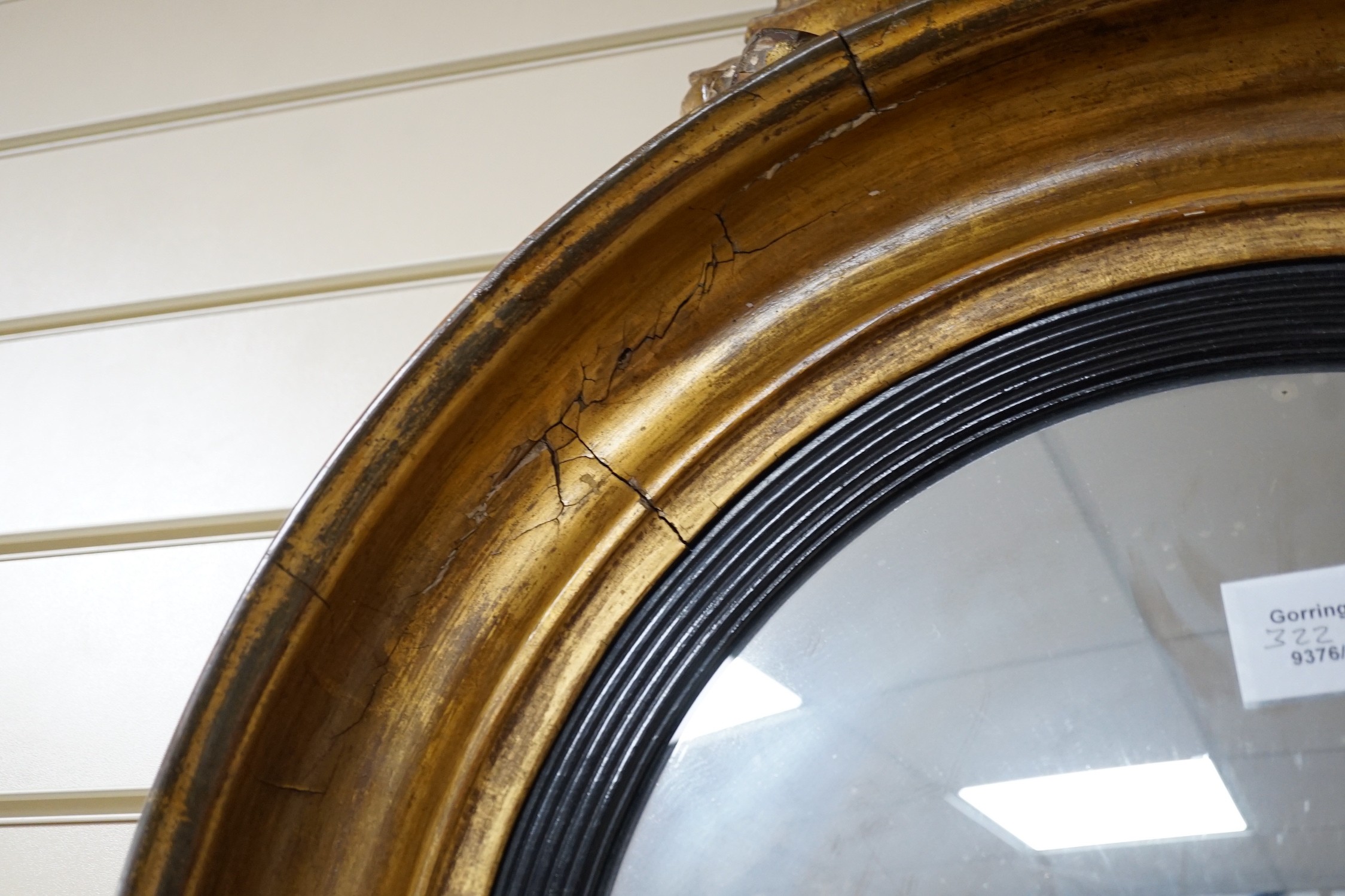 A Regency ebonised and giltwood convex wall mirror, height 87cm *Please note the sale commences at 9am.